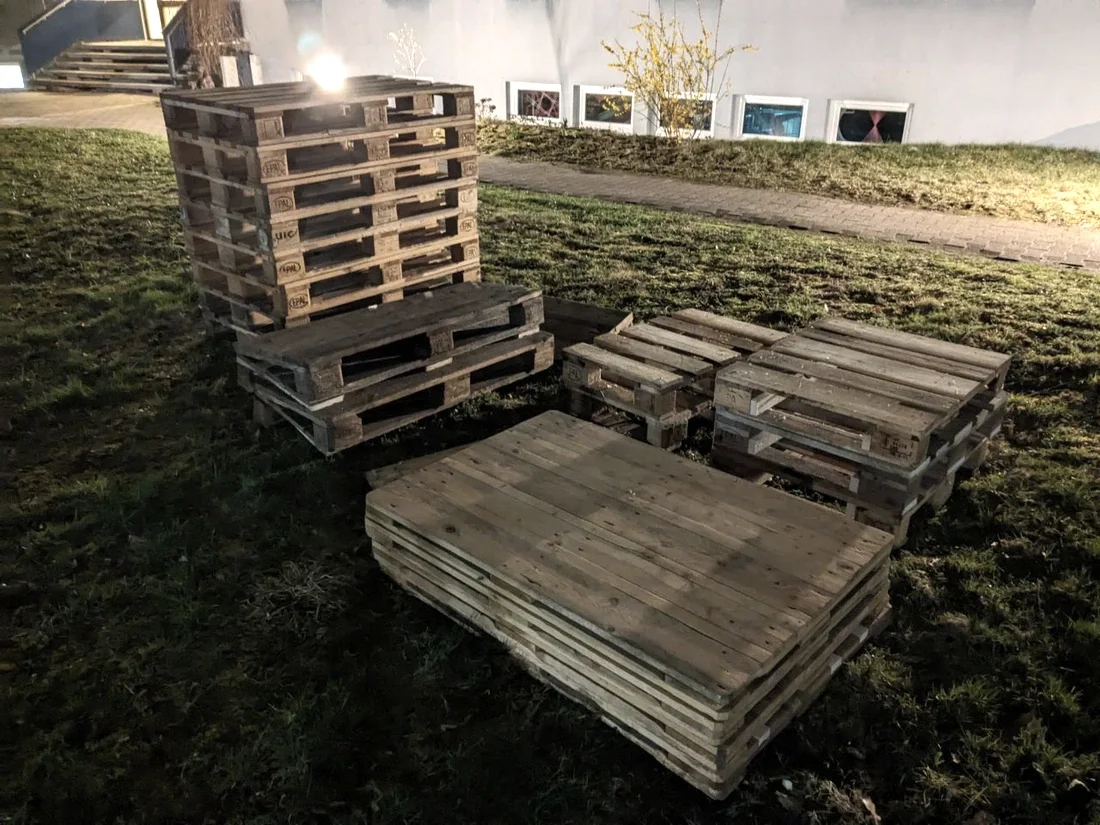 Gestapelte und ausgelegte Holzpaletten als Ausgangsmaterial für die mobile Bar.